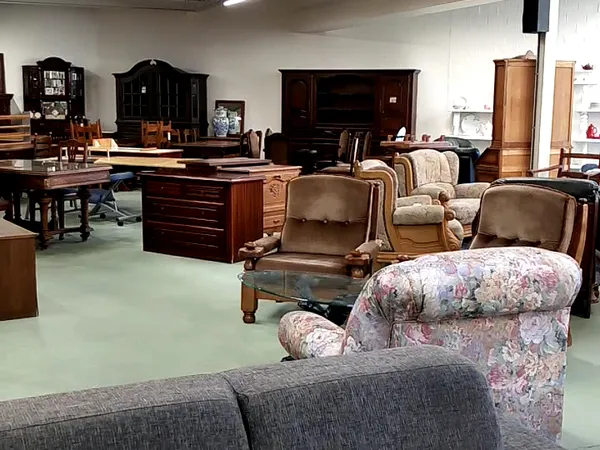 Winkelvloer met meubels: fauteuils, stoelen, kasten en houten tafels in verschillende stijlen