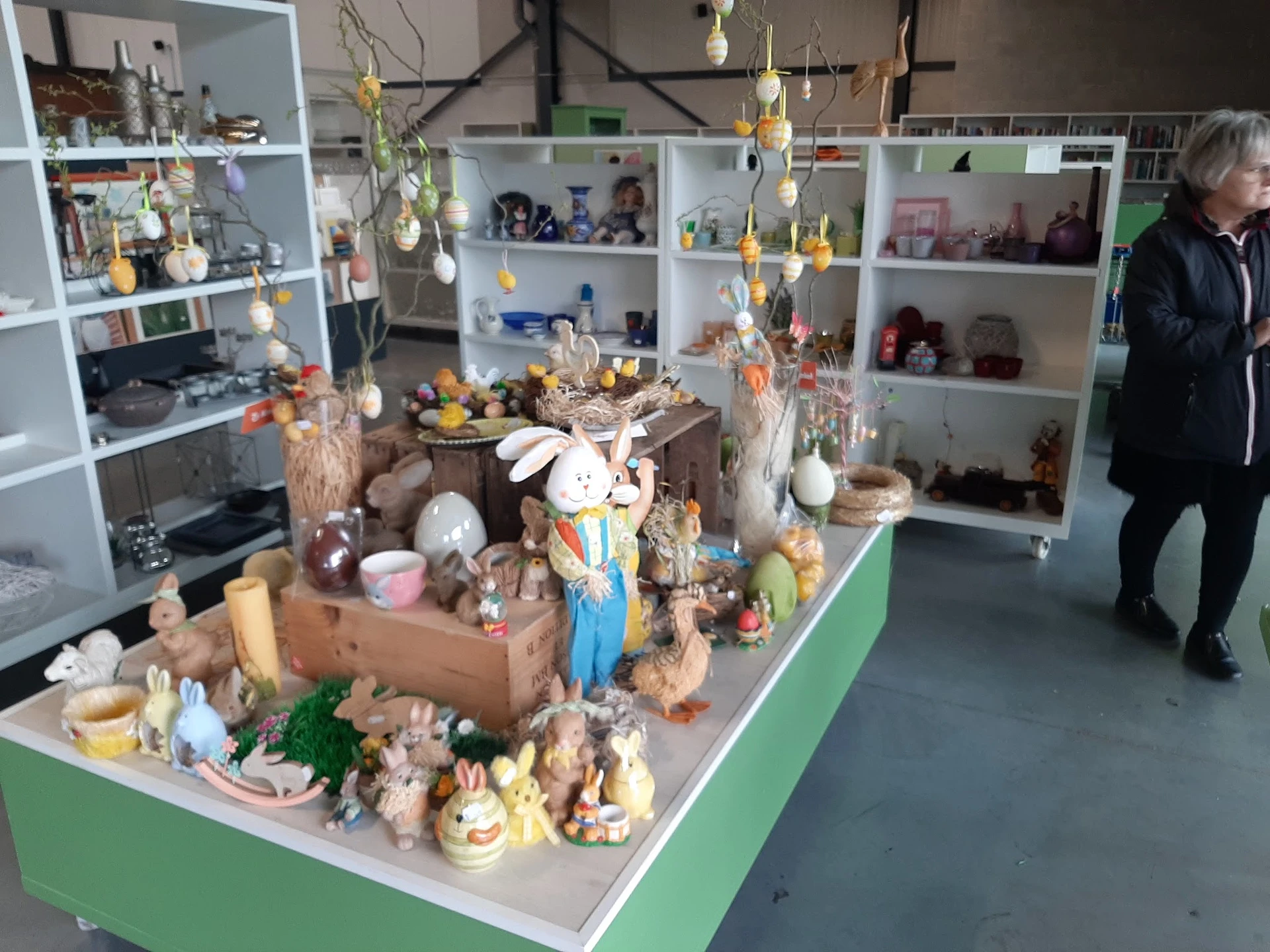 Uitgestalde decoratie-artikelen en paasversiering op een groene tafel in de winkel