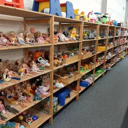 Houten stellingen vol met poppen, speelgoed en verschillende kinderspeelgoed articles