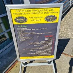 Geel en grijs bord met tekst over helaas niet alles geschikt voor hergebruik en verkoopbeleid van kringloopwinkel