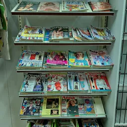 Vier stellingen vol met gebruikt magazines en bladen, netjes uitgestald op metalen rekken