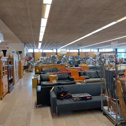 Winkelinterieur met zwarte en oranje banken en meubels op de uitstallingsruimte, heldere plafondverlichting