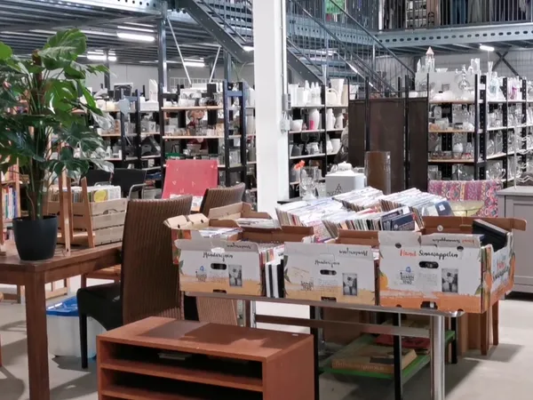 Winkelinterieur met houten meubels, displaytafels en stellingen met diverse goederen