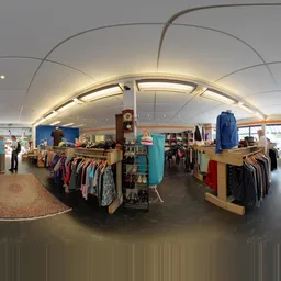 Ruim kringloopwinkelinterieur met kledingrekken, natuurlijke verlichting en grote ramen