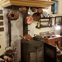 Uitgestalde koperen pannen, ketels en decoratieve borden in een antiekwinkel