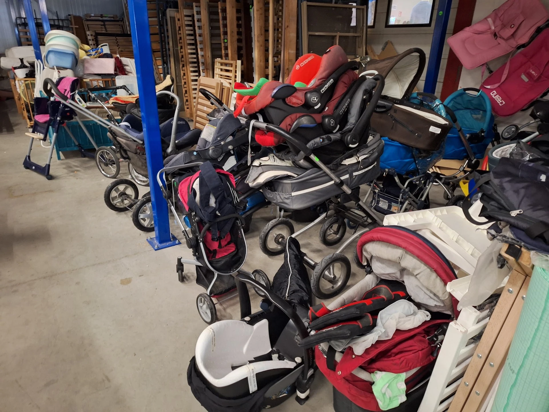 Verzameling tweedehands kinderwagens en buggy's in een opslagruimte