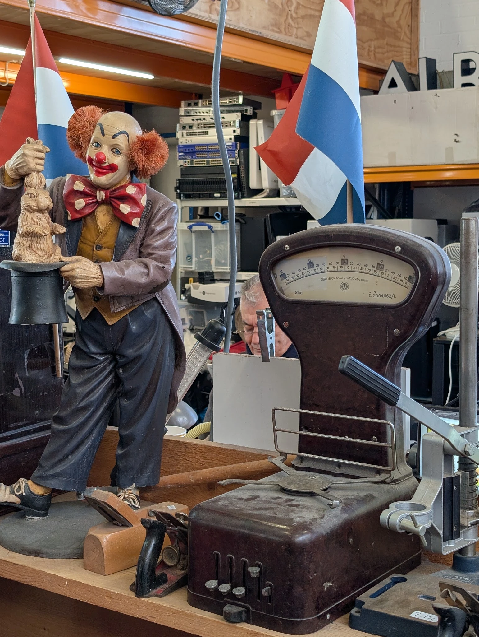 Vintage weegschaal en clownspopdecoratie in de kringloopwinkel