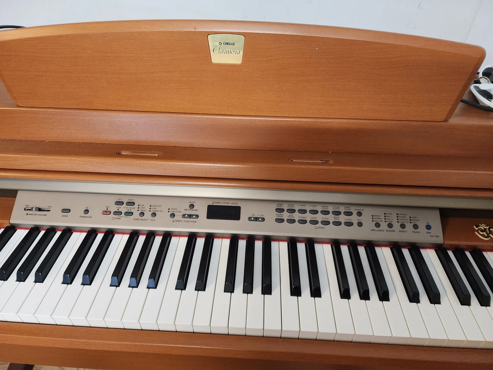 Houten digitale piano met toetsen en bedieningspaneel, close-up vanaf bovenkant gezien