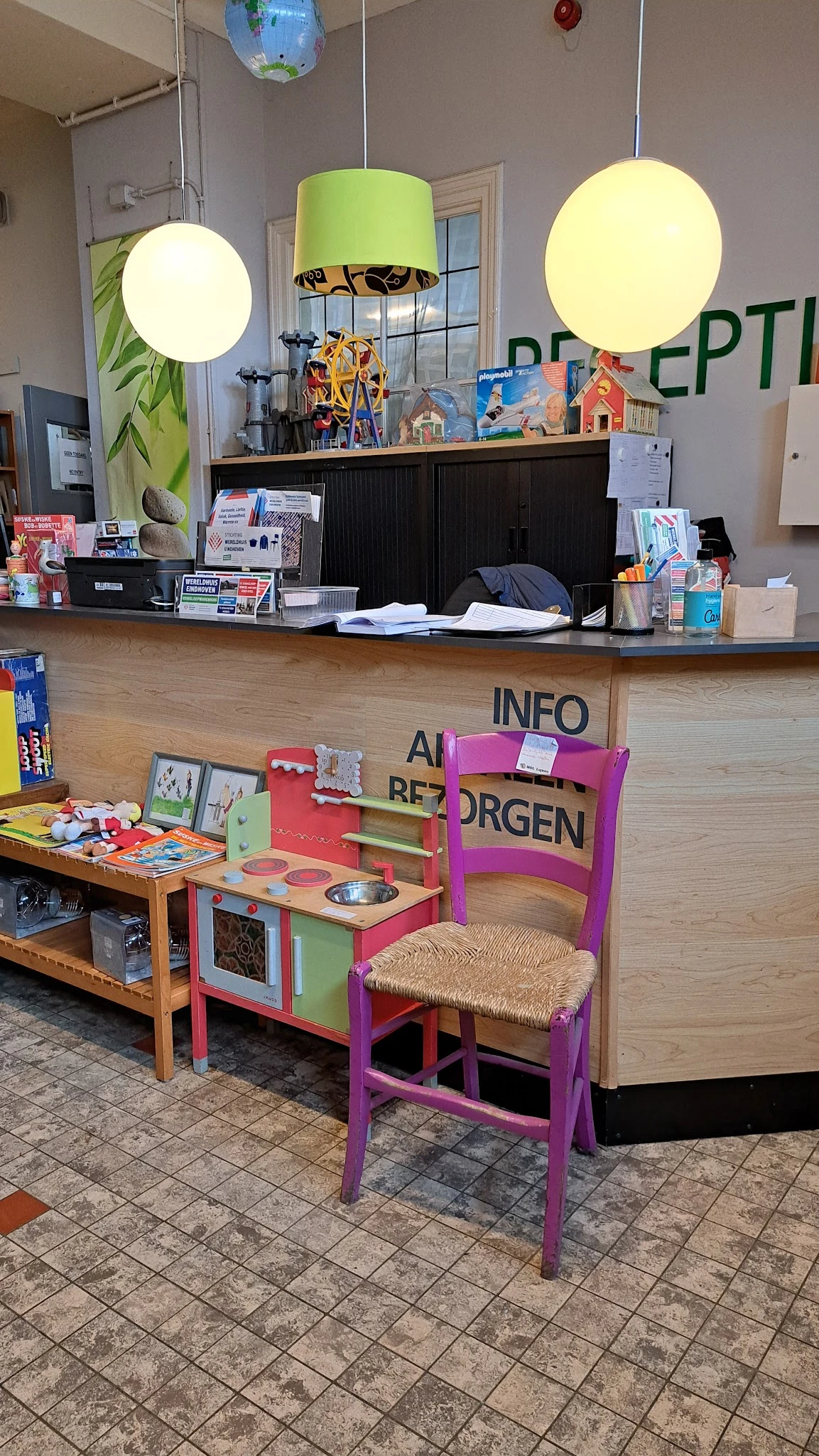 Winkelvloer met kindermeubels, speelgoed en infokaarten achter de toonbank