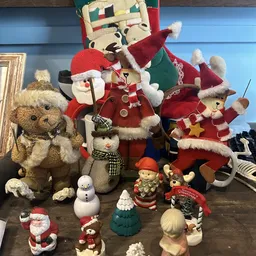 Collectie kerstspeelgoed en decoraties: knuffels, sneeuwpoppen en figuurjes in rood, wit en groen