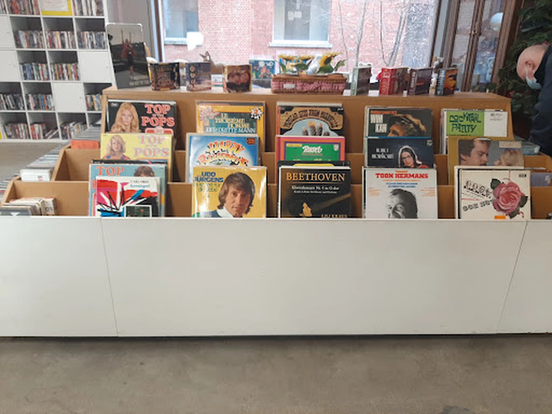 Uitstalling van tweedehands LP's en vinyl records in kartonnen dozen op een balie