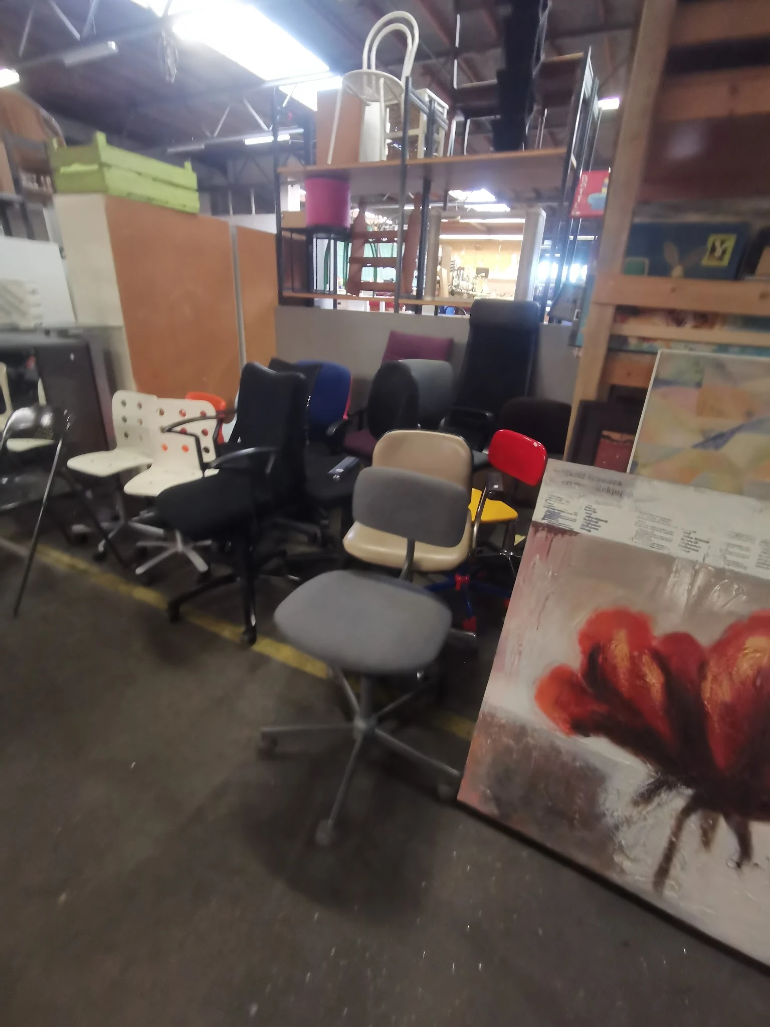 Verzameling tweedehands bureaustoel en kantoorstoelen in verschillende kleuren in de winkel