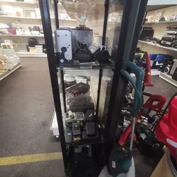 Stellingkast met tweedehands elektronische apparaten en huishoudelijke items in een kringloopwinkel