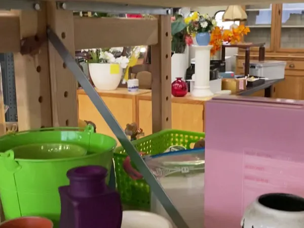 Winkelbinnenruimte met kleurrijke opbergkisten en dozen, stellingen op de achtergrond met decoraties