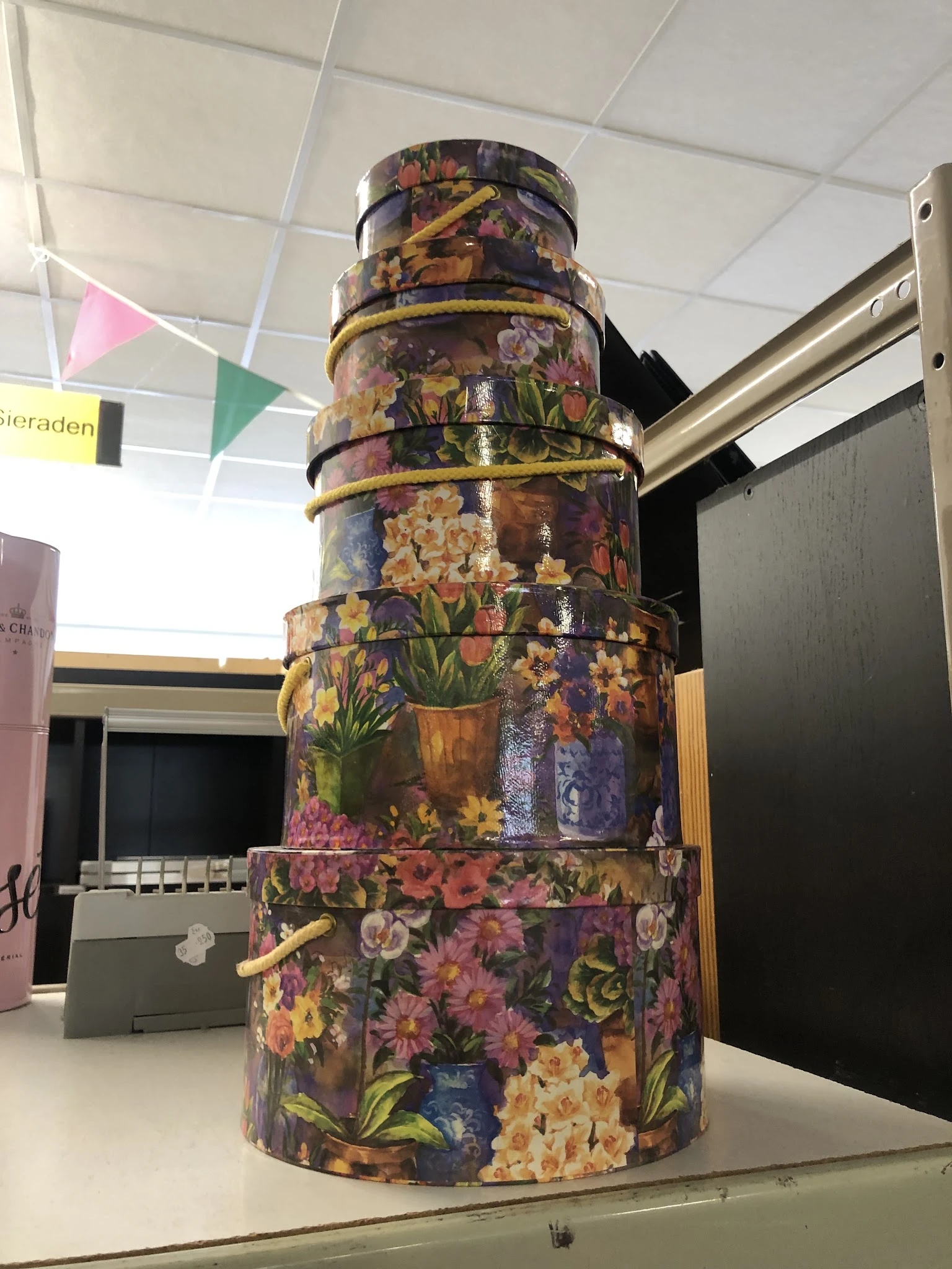 Stapel decoratieve dozen met bloemenprint en gouden banden, gestapeld als displayobject